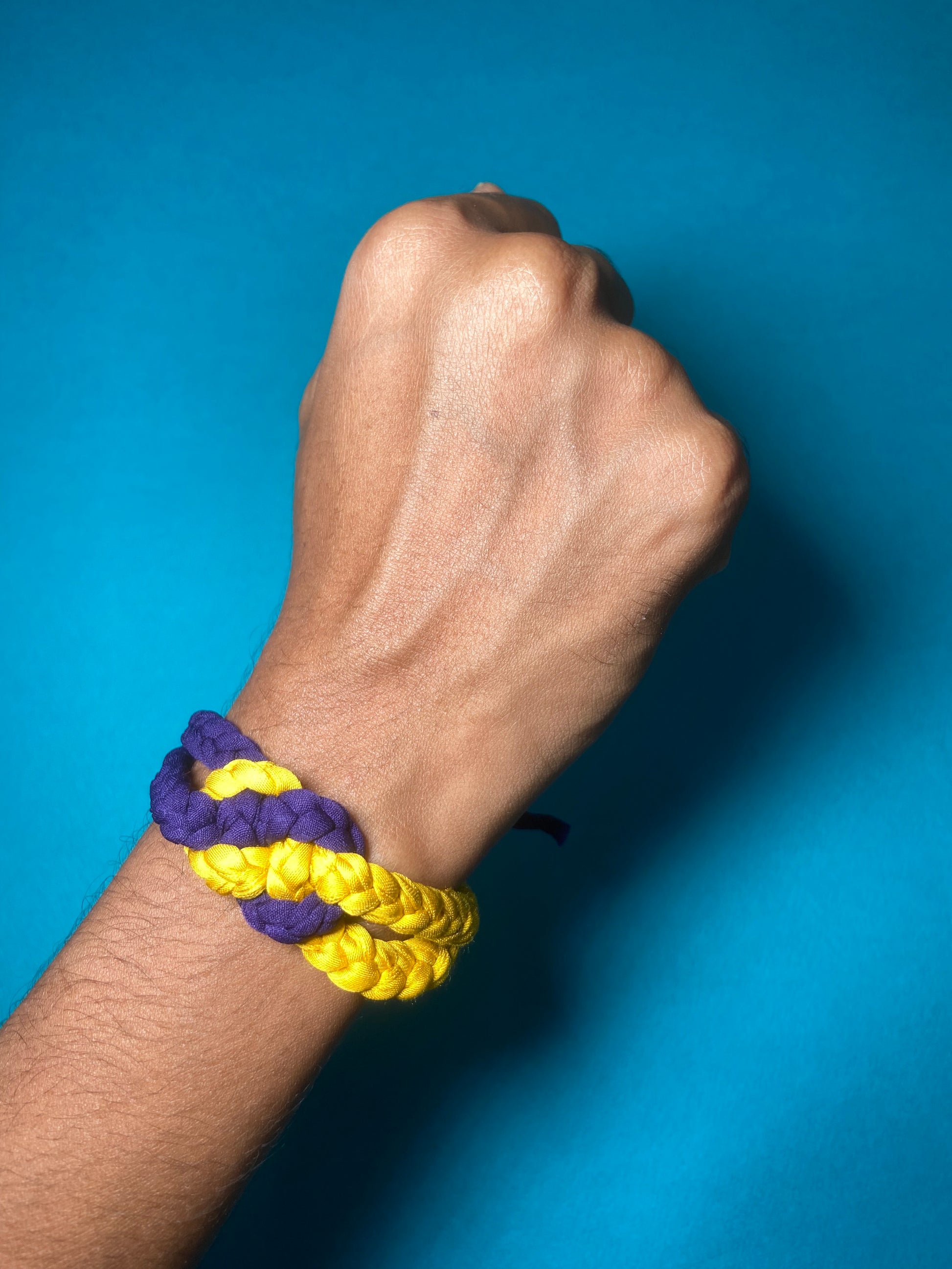 Whimsy-Twist-Upcycled-Kids-Rakhi-purple-yellow-on-hand