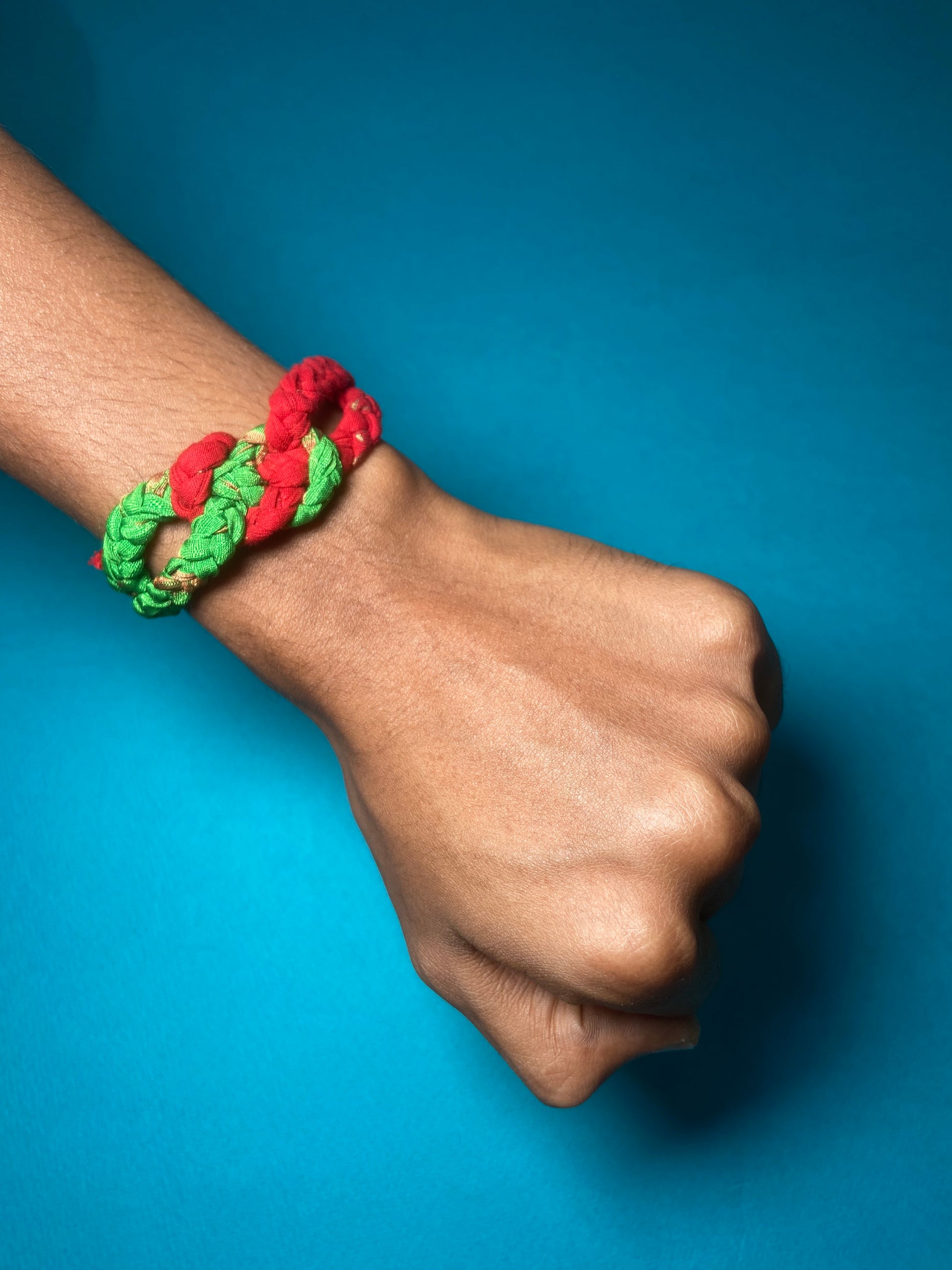 Whimsy-Twist-Upcycled-Kids-Rakhi-red-green-on-hand